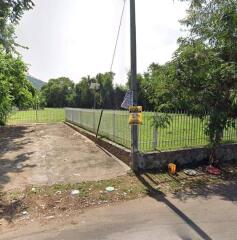 Driveway leading to gated green area