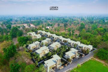 Aerial view of a modern residential development surrounded by greenery