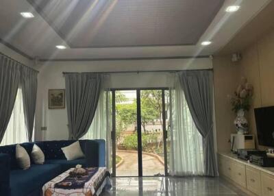 Spacious living room with large chandelier and glass sliding doors