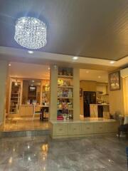 Living room with elegant chandelier and built-in shelving