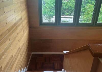 Indoor staircase with wooden steps and large windows