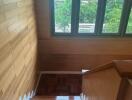 Indoor staircase with wooden steps and large windows