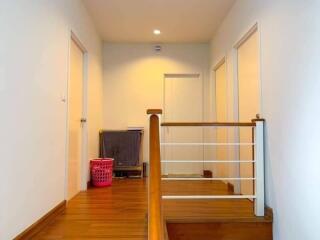 Hallway with wooden flooring and doors