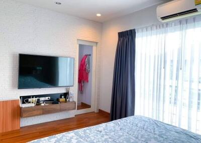 Modern bedroom with TV and window