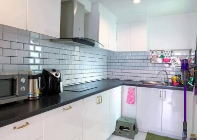 Modern kitchen with sleek black countertop and stainless steel appliances