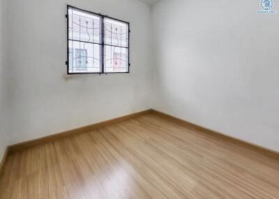 Minimalist empty bedroom with wooden flooring and window