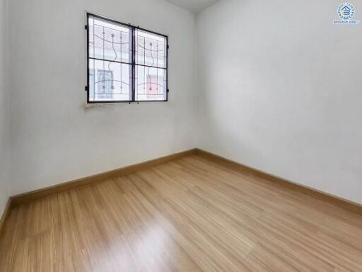 Minimalist empty bedroom with wooden flooring and window