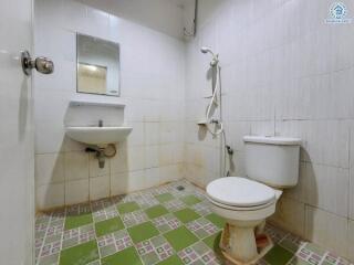 Bathroom with sink, mirror, toilet, and shower