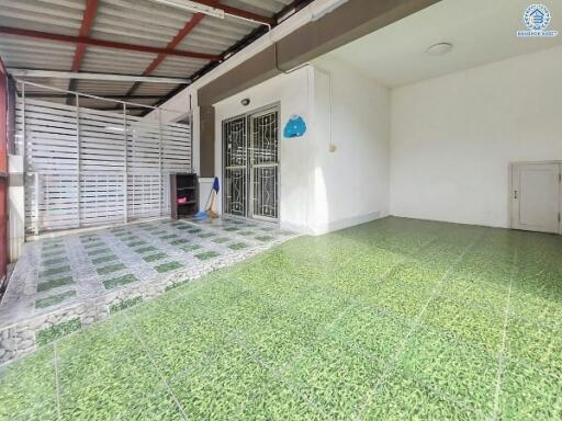Covered outdoor space with tiled flooring