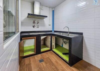 Modern kitchen with cabinets open showcasing under-sink storage
