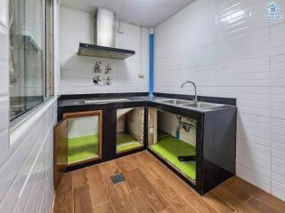 Modern kitchen with cabinets open showcasing under-sink storage