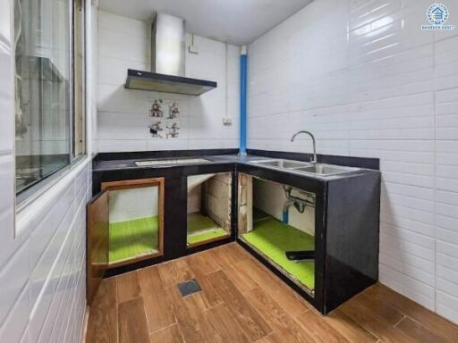 Modern kitchen with cabinets open showcasing under-sink storage