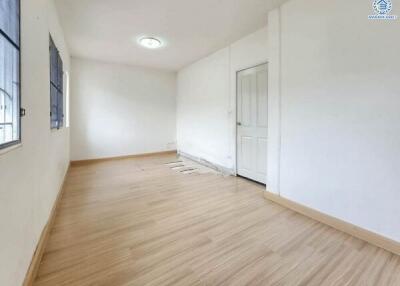 Empty room with wooden floor and white walls