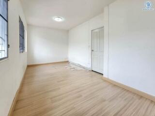 Empty room with wooden floor and white walls