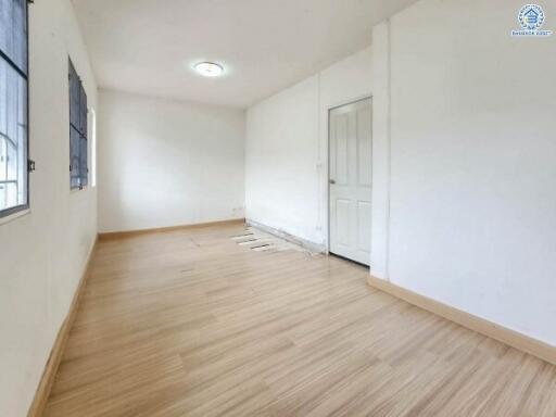 Empty room with wooden floor and white walls