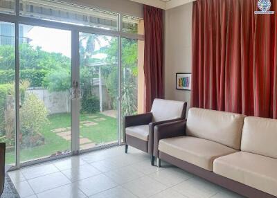 Bright living room with large glass sliding door and garden view