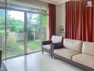 Bright living room with large glass sliding door and garden view