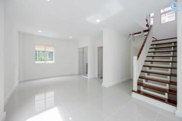 Spacious and bright main living area with stairway