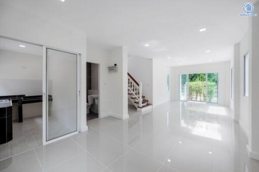 Bright and spacious living area with modern finish and staircase