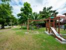 Outdoor playground area with slide and greenery