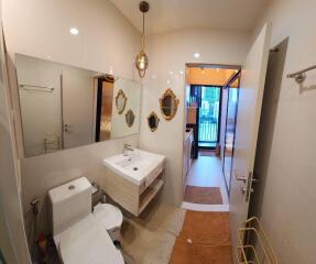 Modern bathroom with floating sink, toilet, and mirrors