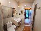 Modern bathroom with floating sink, toilet, and mirrors