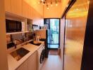 Modern kitchen with wooden cabinets and laundry machine