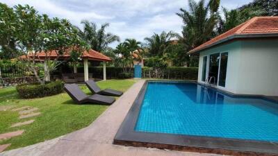 Outdoor area with swimming pool and lounging chairs