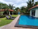 Outdoor area with swimming pool and lounging chairs