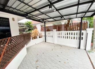 Covered outdoor space with fencing and plants