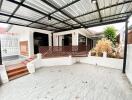 Covered outdoor patio with tiles and wood accents