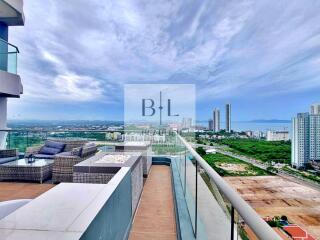 Balcony with a view of high-rise buildings and scenic landscape