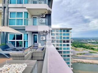 Modern apartment building with outdoor lounge area and scenic view