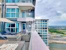 Modern apartment building with outdoor lounge area and scenic view