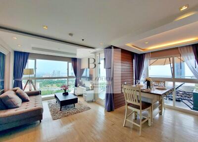 Spacious living and dining area with natural light and city view