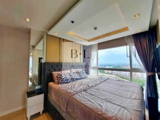 Modern bedroom with large windows and city view