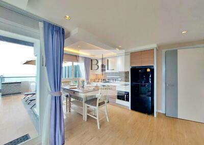 Modern kitchen with dining area and access to a balcony