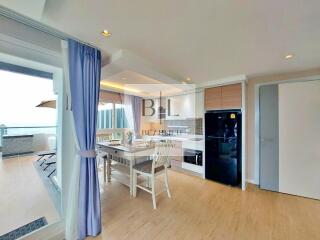 Modern kitchen with dining area and access to a balcony