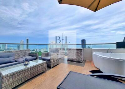 Spacious outdoor terrace with city and ocean views, featuring outdoor seating and a bathtub