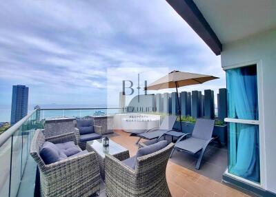 Spacious balcony with outdoor seating and ocean view
