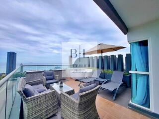 Spacious balcony with outdoor seating and ocean view