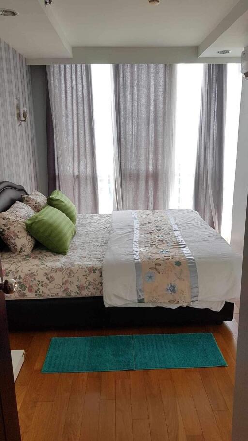 Bedroom with bed, pillows, and curtains