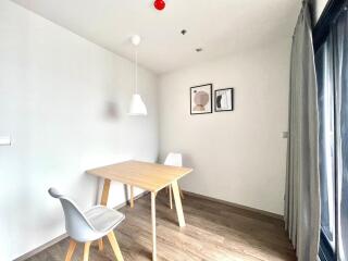 Minimalist dining area with wooden table and modern chairs