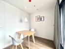 Minimalist dining area with wooden table and modern chairs