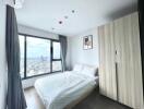 Bright bedroom with large windows and city view