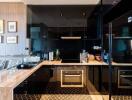 Modern kitchen with black cabinetry, marble countertops, and stainless steel appliances