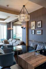 Modern living room with chandelier and artwork on the wall