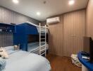 Bedroom with bunk beds, single bed, TV, and storage