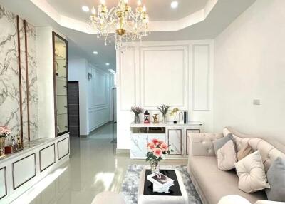 Spacious and elegantly designed living room with chandelier and modern furniture