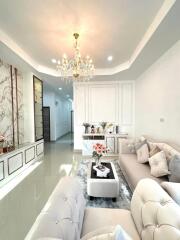 Spacious and elegantly designed living room with chandelier and modern furniture